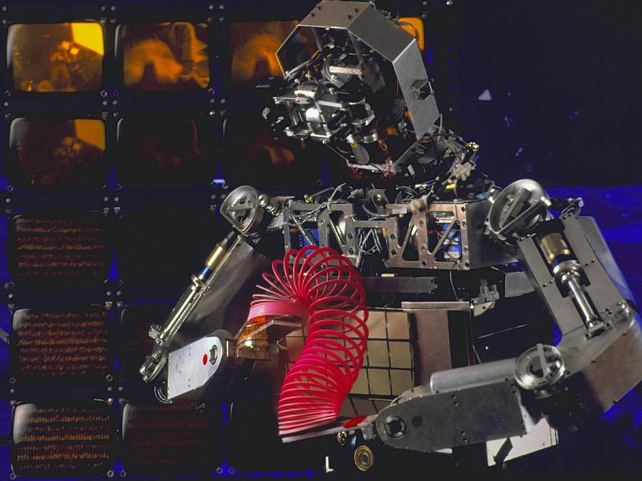 A humanoid robot manipulates a Slinky.