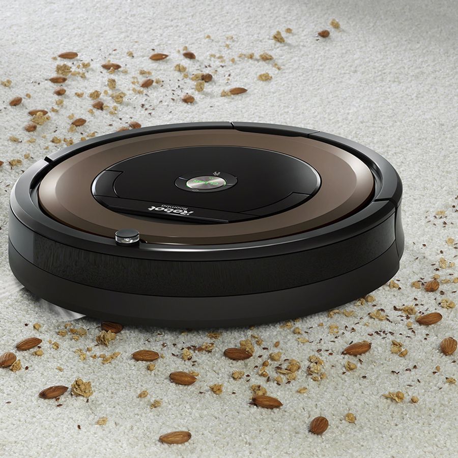 A robotic vacuum cleans a dirty carpet.