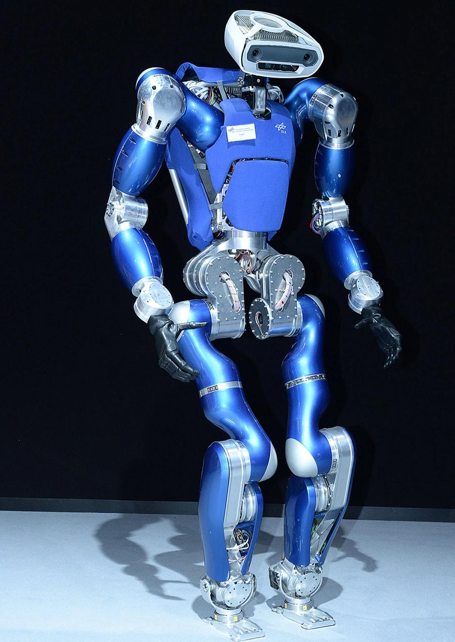 A shiny blue and silver bipedal humanoid with powerful arms, black hands, and a cute rounded rectangular face with cameras and sensors, and two jointed legs.