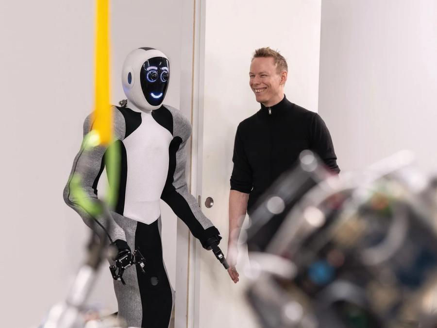 The humanoid robot EVE smiles at a human.