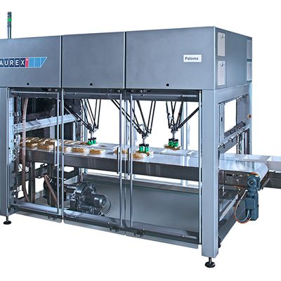 A large pick and place machine packages food.