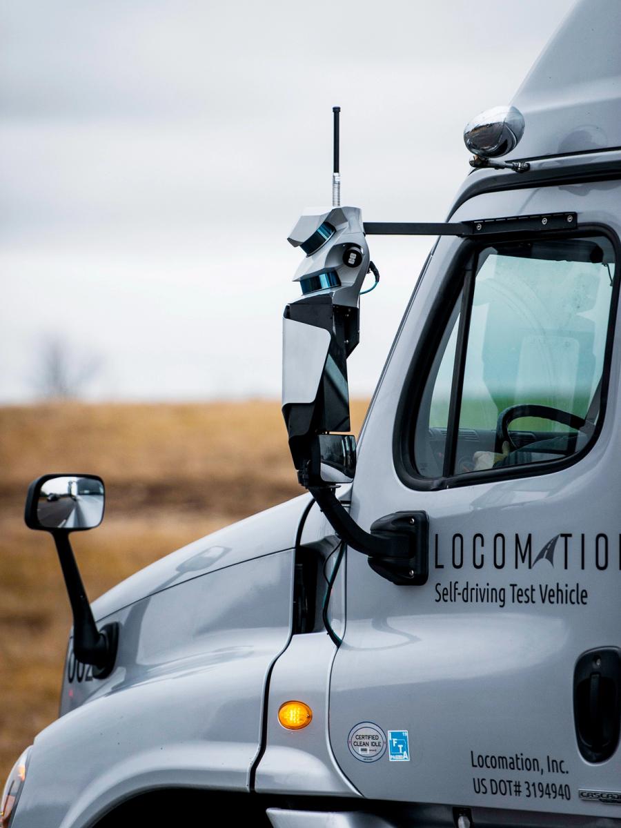 Close-up on the sensors and cameras attached to the front of a freight truck.