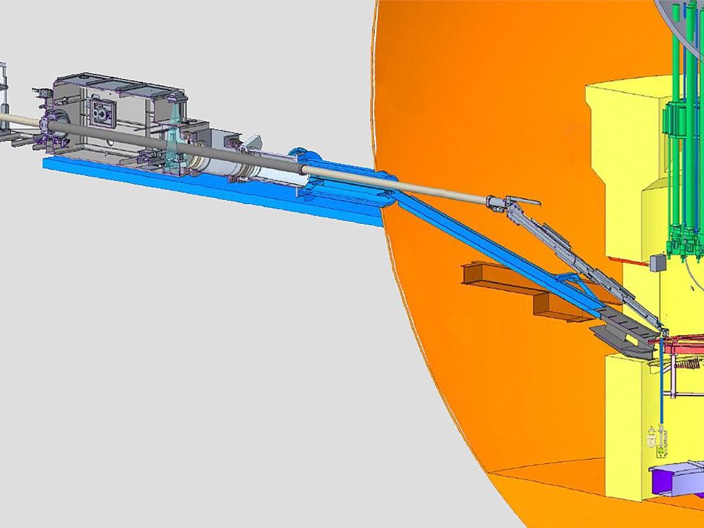 A line drawing shows the telescopic robotic device retrieving fuel from a reactor.