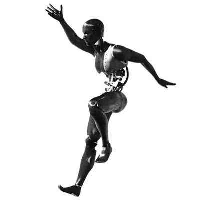 A black humanoid in an active position as if catching itself while falling. It's arms are thrown out to the side, one leg is bent up and the other foot has only the heel on the ground.