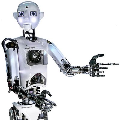 An expressive humanoid robot with a bright round face, a shiny torso with sensors, and two arms with black jointed fingers.