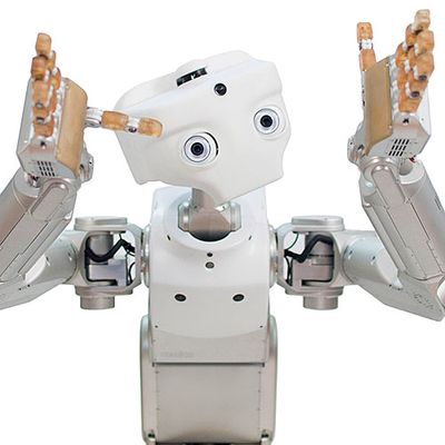 A white robot with a simple face with two eyes and a camera. It has two hands with five gripper fingers which it holds up as if gesturing.