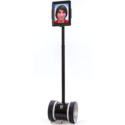 A wheeled telepresence robot with a long neck holding a monitor showing a smiling face.