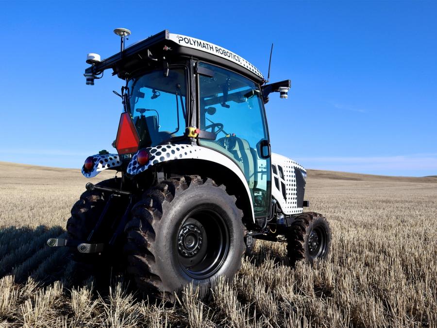 Rear side view of an empty Polymath Robotics autonomous tractor sits in a field.