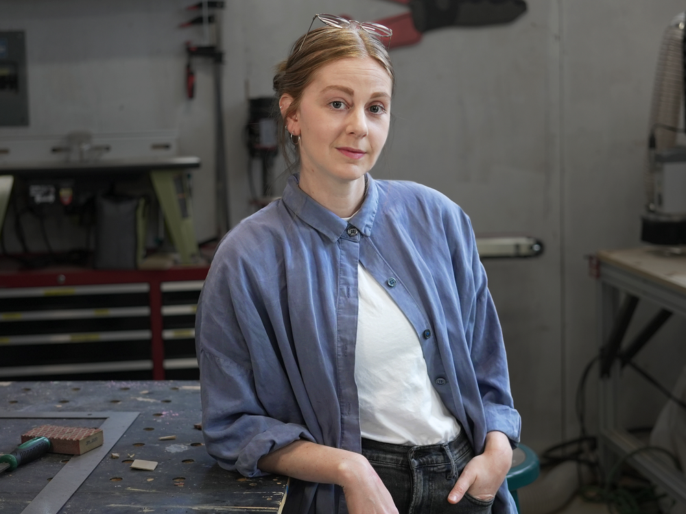 A photo of a woman in a workshop.